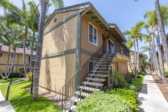 Front view of a two-story apartment building with external staircases.
