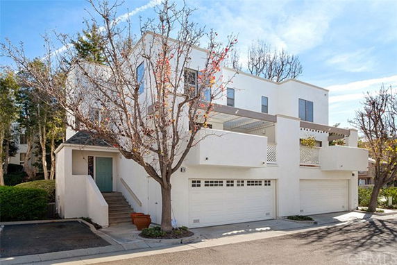Front view of a multi-story house with a double garage.