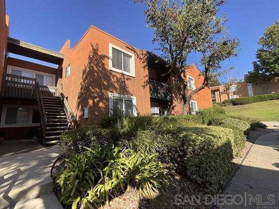 Front view of a two-story apartment building with exterior stairs.