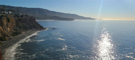 Panoramic view of a coastal area with cliffs and ocean.