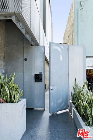 Entrance view of a modern building with tall metal doors.