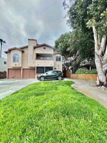 Front view of a multi-story house with a double garage.