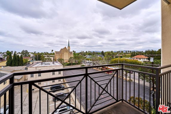 Panoramic cityscape view from a building balcony.