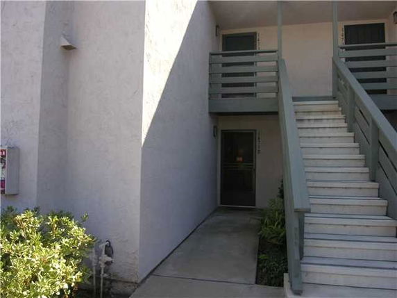 Front view of a building with stairs leading to the entrance.
