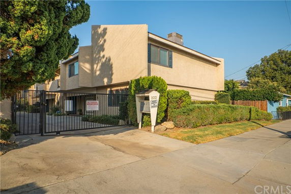 Front view of a two-story building with a gated entrance.