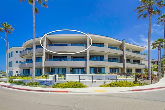 Front view of a modern multi-story building with curved balconies.