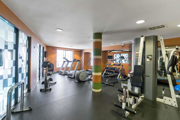 Indoor gym area with exercise machines and weights