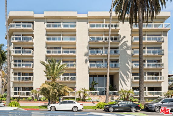 Front view of a multi-story residential building with balconies.