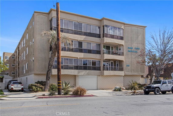 Front view of a multi-story residential building with balconies.