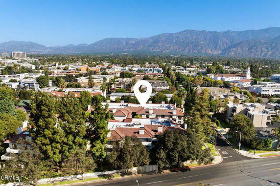 Aerial view of a suburban area with mountains in the background.