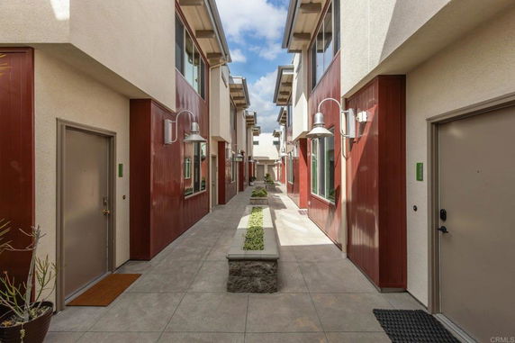 View of a modern apartment building with multiple entrances.