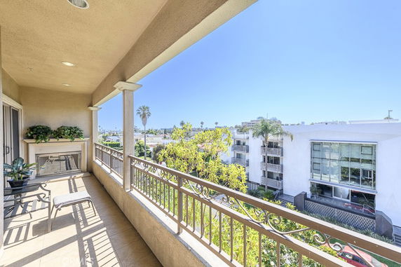View from a balcony overlooking surrounding buildings and trees.