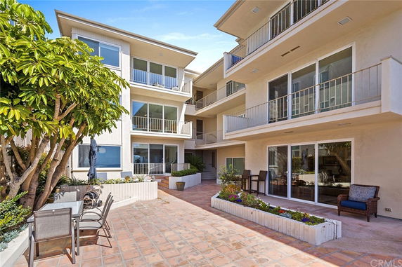 Front view of a multi-story residential building with balconies.