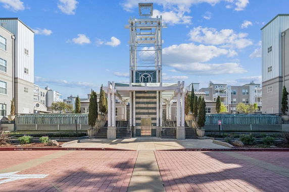 Front view of a modern building with symmetrical design and decorative pillars.