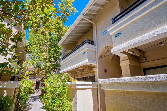 Front view of a multi-story residential building with balconies.