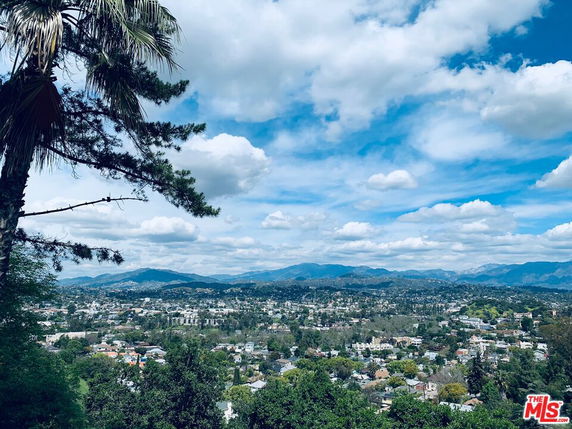 Wide angle view of a cityscape with mountains in the background.