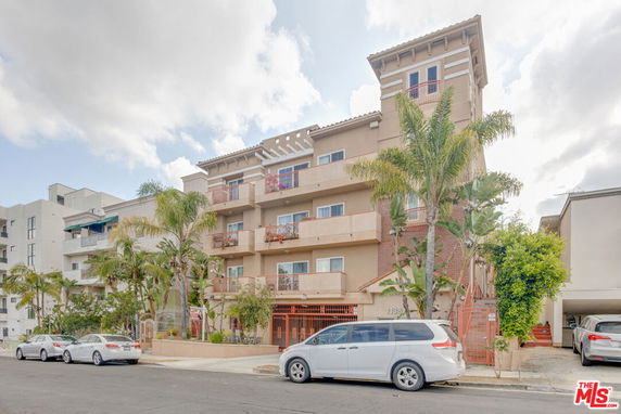 Front view of a multi-story residential building with balconies.