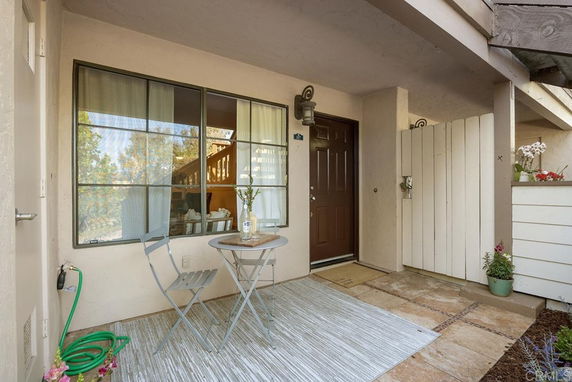 Front view of a house entrance with a small patio area.