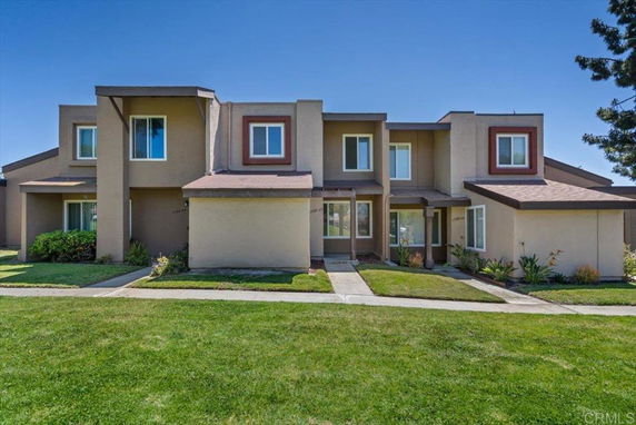 Front view of a two-story multi-family house with multiple entrances.