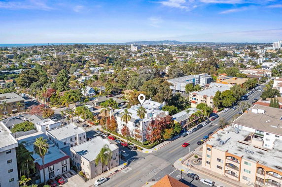 Aerial view of a residential area with various buildings and greenery.