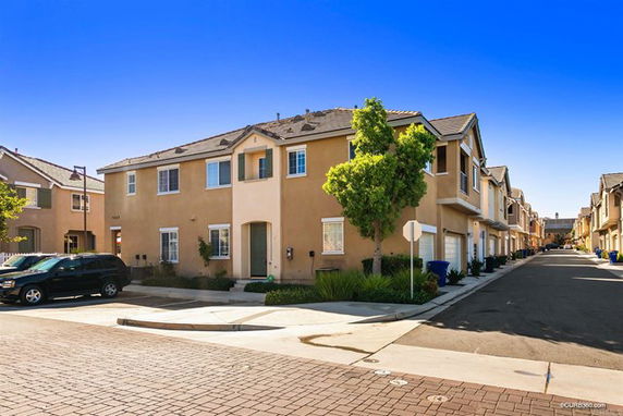 Front view of a two-story townhouse with a corner location.