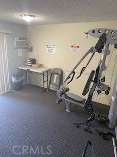 Indoor area featuring gym equipment and a small table.