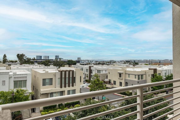 View of multiple apartment buildings and distant high-rises from a balcony.