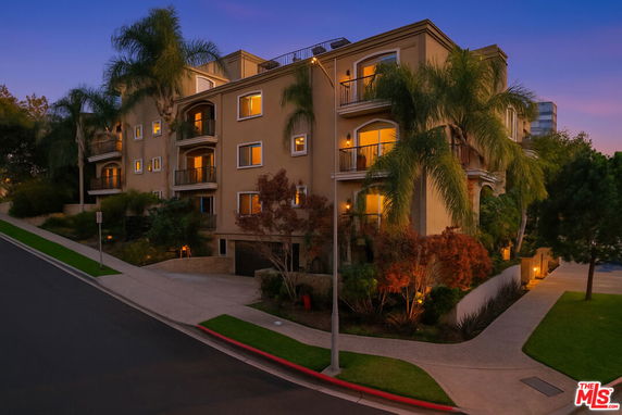 Front view of a multi-story residential building with balconies.