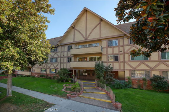 Front view of a multi-story building with Tudor-style architecture.