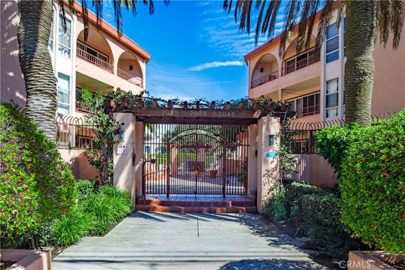 Front view of a multi-story building with gated entrance.