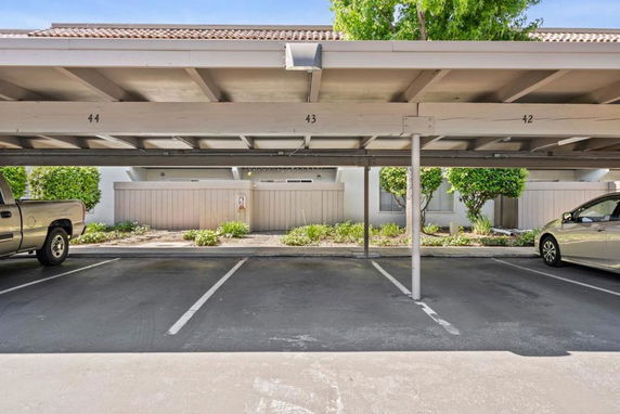 Covered outdoor parking area with numbered spaces.