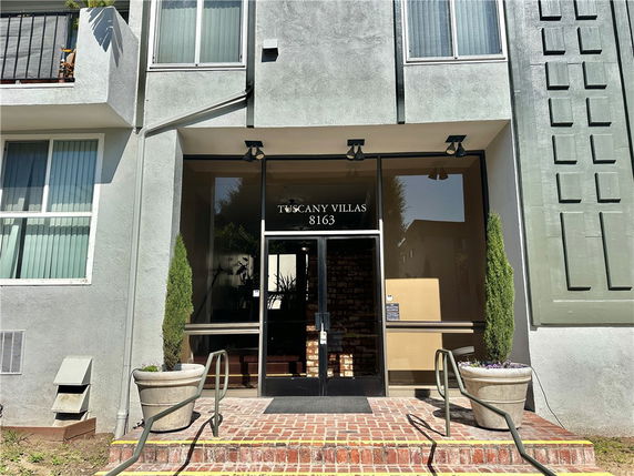 Front view of a building with the entrance labeled Tuscany Villas 8163.