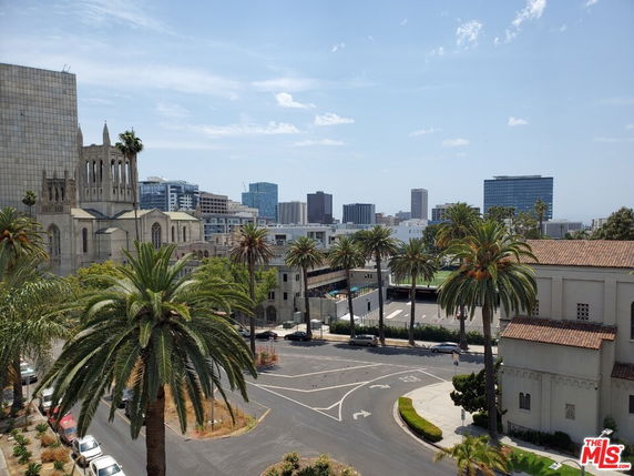 Panoramic view of a cityscape with historic and modern buildings.