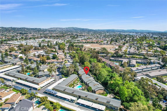 Aerial view of a residential area with multiple buildings and surrounding greenery.