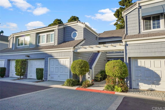 Front view of a multi-unit residential building with garages.
