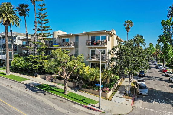 Front view of a multi-story apartment building with balconies.