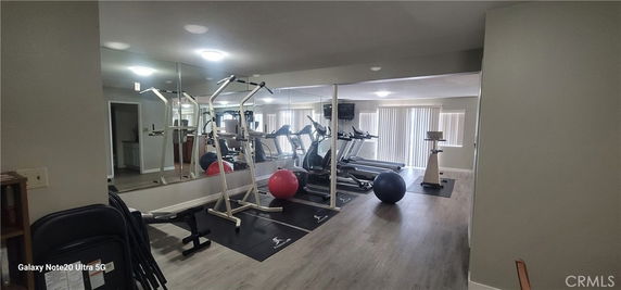 Indoor gym area with exercise equipment and mirrors