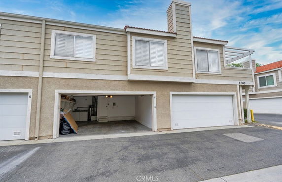 Front view of a two-story building with a double garage.