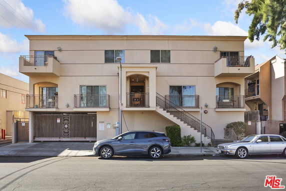 Front view of a multi-story residential building with balconies.