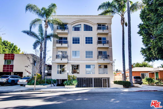 Front view of a multi-story residential building with balconies.