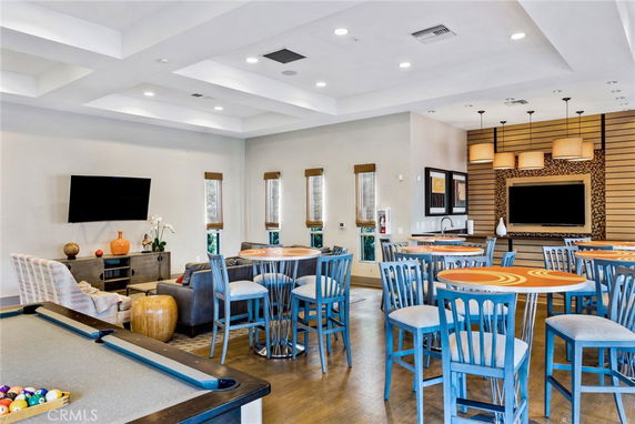 Recreation area with seating, tables, and billiards.