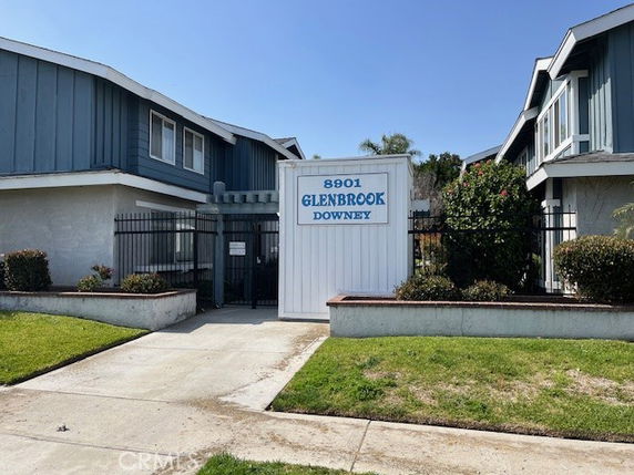 Front view of a residential building with gated entrance and sign reading '8901 Glenbrook Downey.'