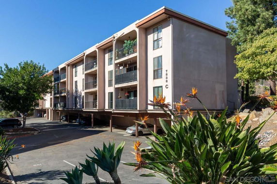 Front view of a multi-story apartment building with balconies.