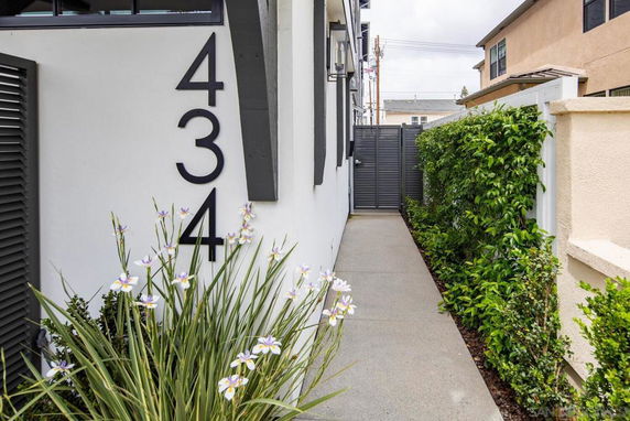 Side entrance view of a house with a visible house number and pathway.