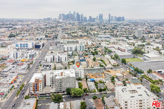 Aerial panoramic view of a cityscape with various buildings and streets.