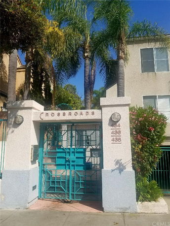 Front view of a building entrance with a gated entryway marked 'CROSSROADS'.