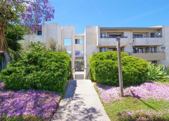 Front view of a multi-story building with balconies.