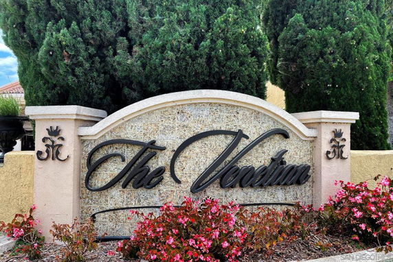 Stone signage with 'The Venetian' in black script on the exterior of a building.