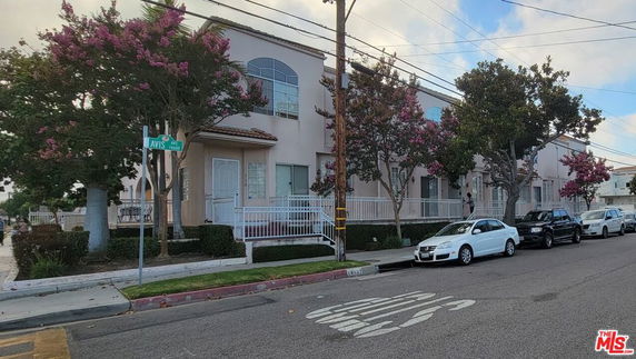 Front view of a multi-story building on a street corner.