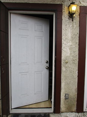 Front view of a door on a building with a light fixture above.